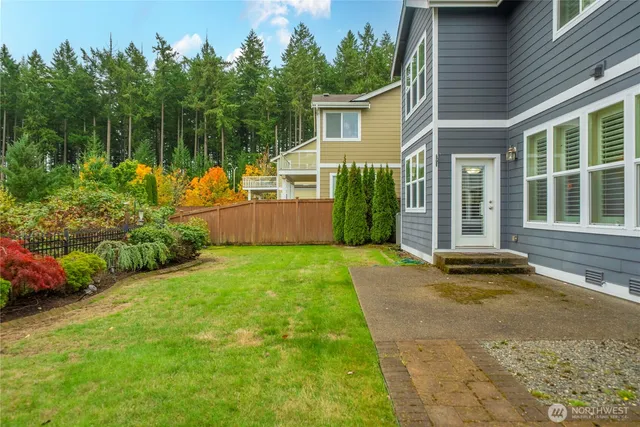 a view of a backyard with table and chairs and potted plants