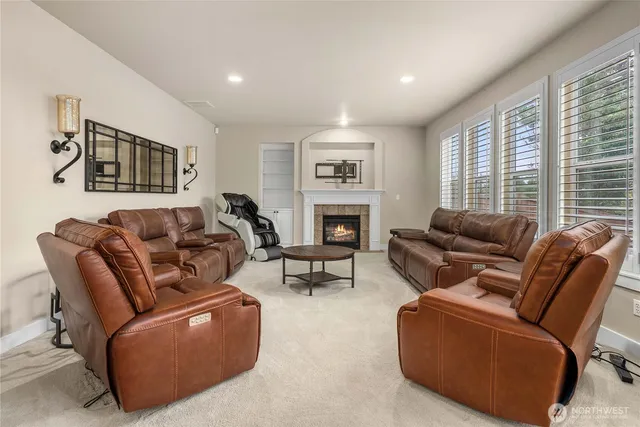 a living room with furniture a large window and a fireplace
