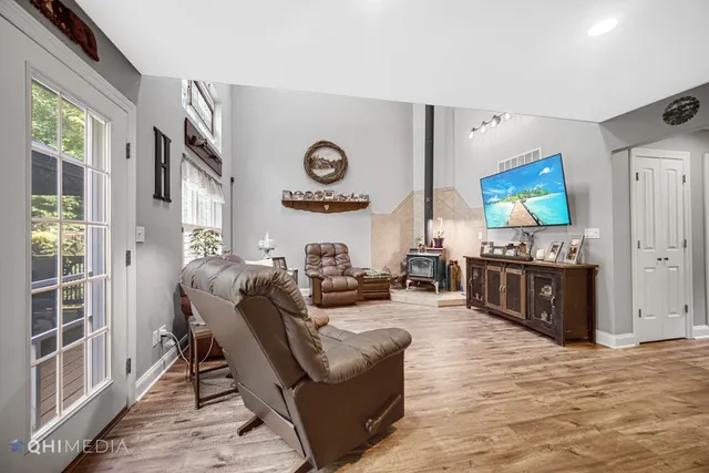 a living room with fireplace furniture and a flat screen tv