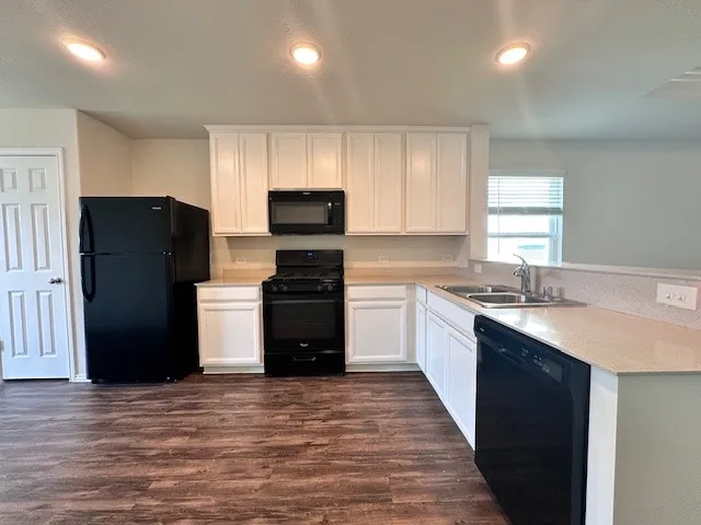 a kitchen with a refrigerator and a sink