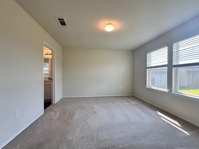 an empty room with windows and entrance