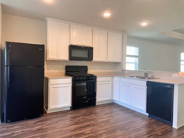 a kitchen with a refrigerator and a stove top oven