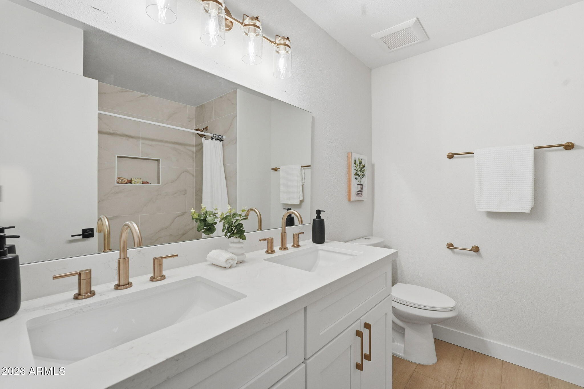 1663 West Monte Avenue Mesa, AZ 85202 - Photo 13 of 21 a bathroom with a granite countertop sink a toilet and a mirror