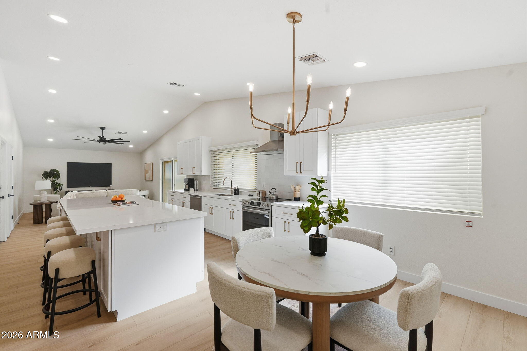 1663 West Monte Avenue Mesa, AZ 85202 - Photo 3 of 21 a view of a dining room and livingroom with furniture wooden floor a chandelier
