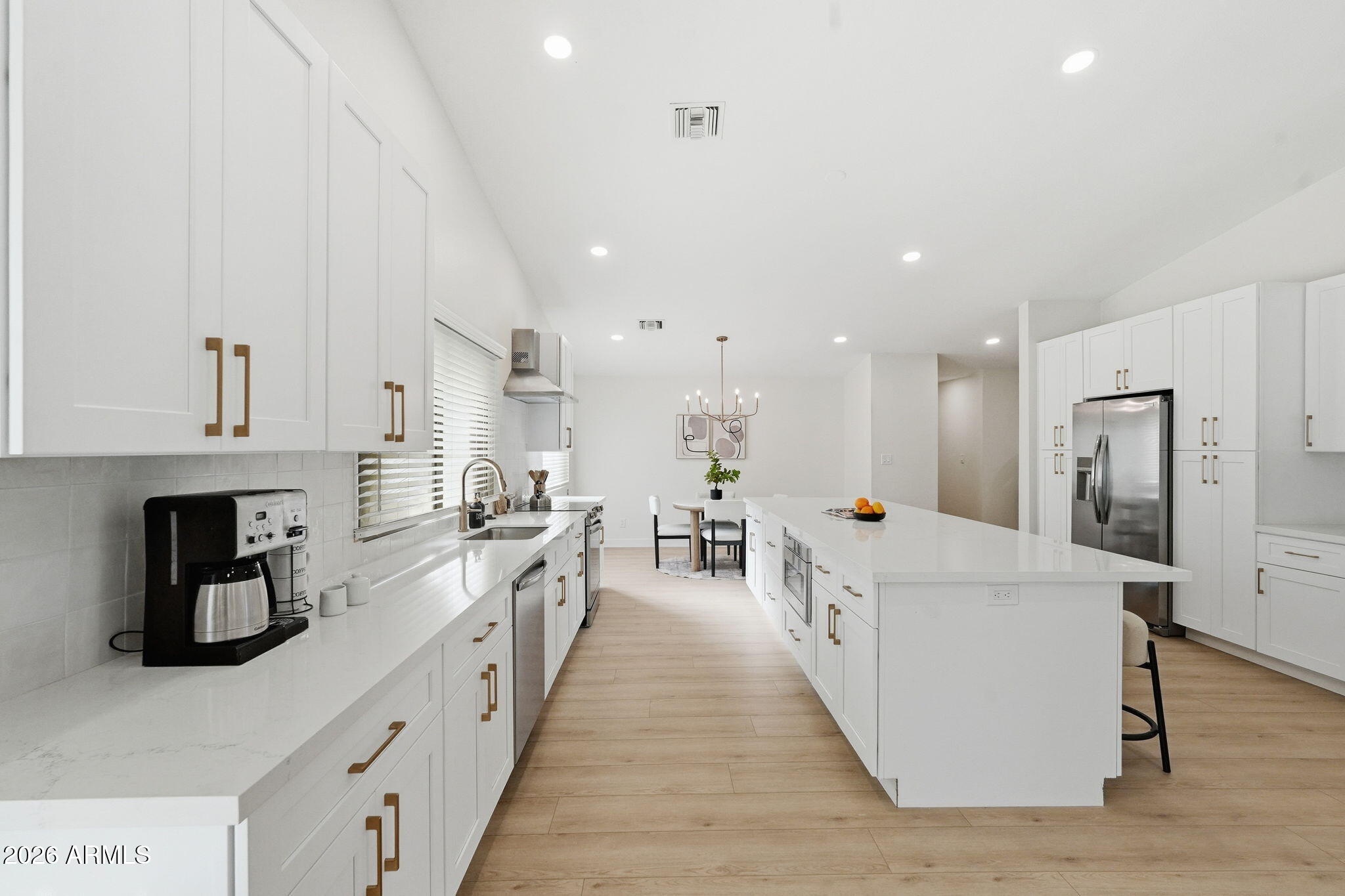1663 West Monte Avenue Mesa, AZ 85202 - Photo 8 of 21 a large white kitchen with stainless steel appliances lots of counter space and window