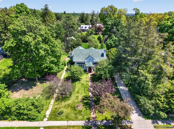 an aerial view of a house with a yard
