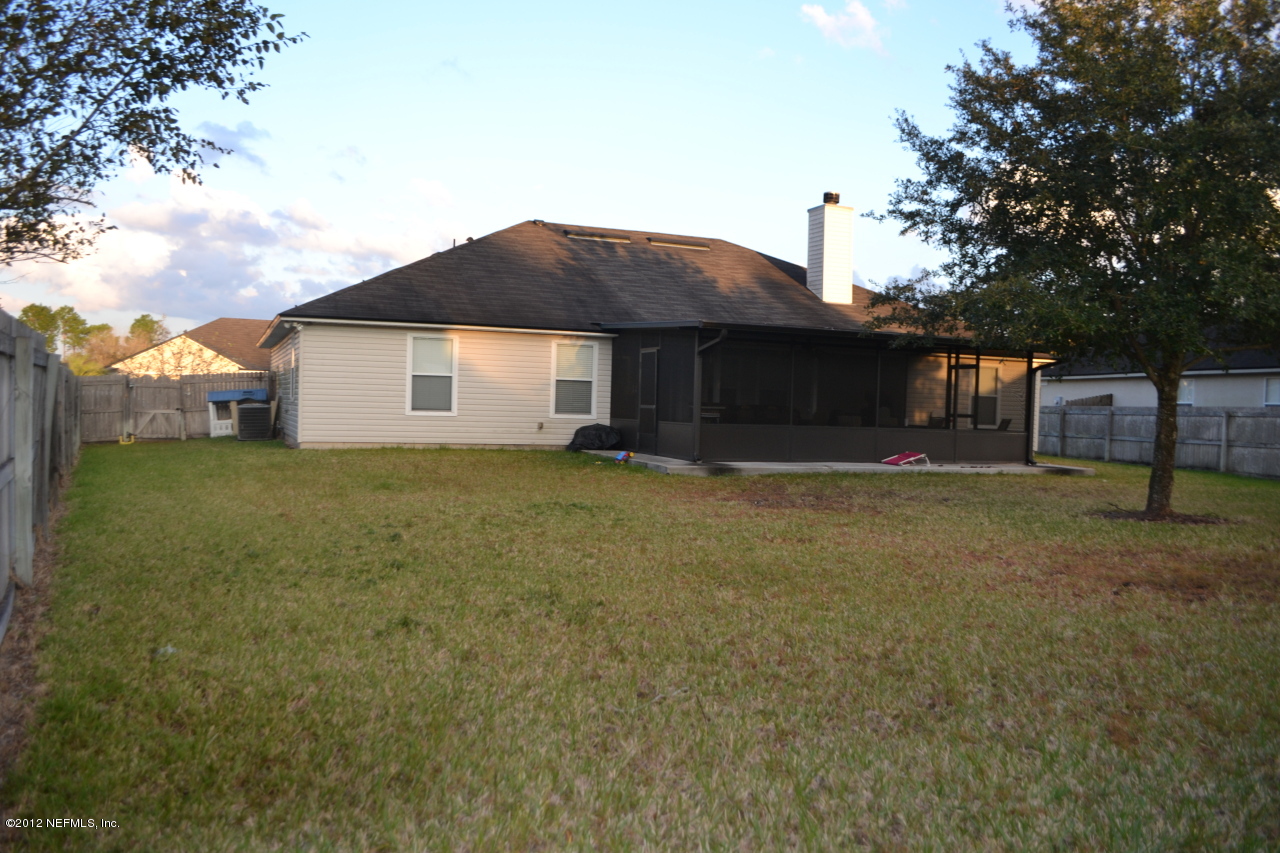12058 Spring Ridge Drive Jacksonville, FL 32258 - Photo 3 of 9 a view of a house with a yard