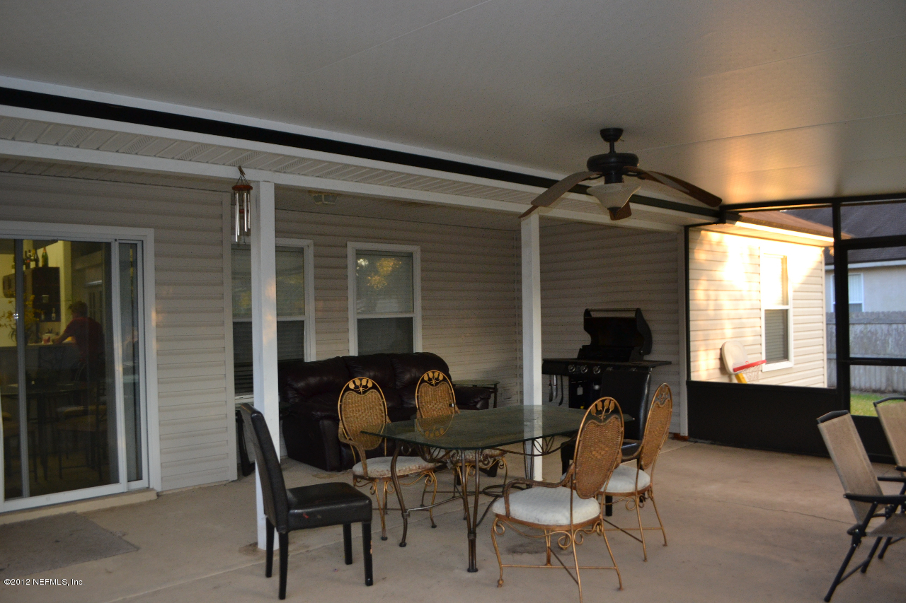 12058 Spring Ridge Drive Jacksonville, FL 32258 - Photo 4 of 9 a view of a workspace with furniture and a window