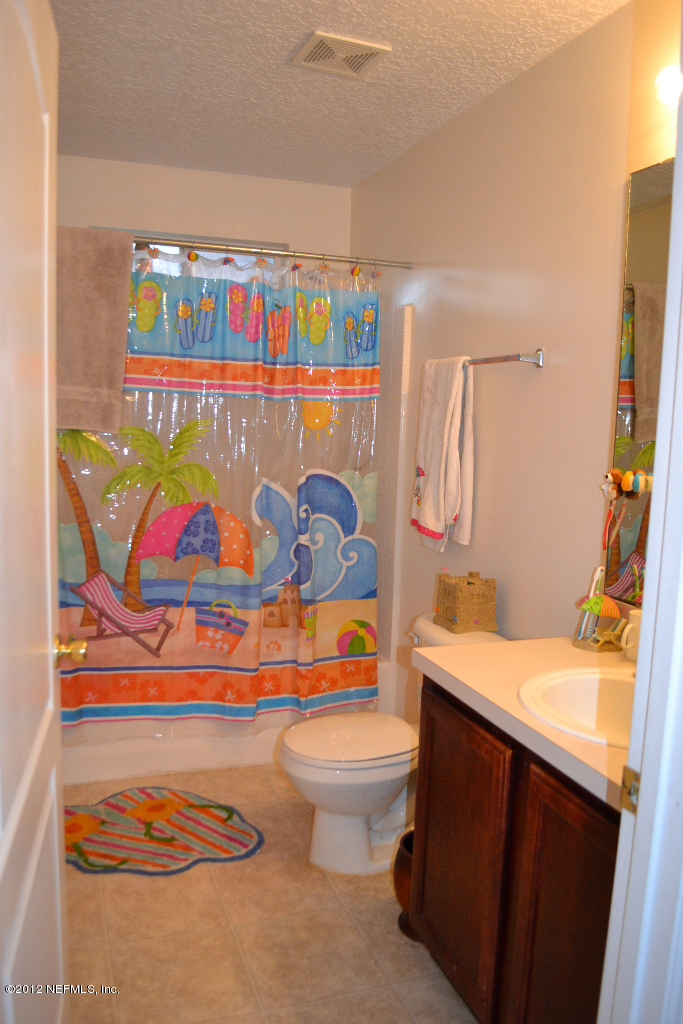 12058 Spring Ridge Drive Jacksonville, FL 32258 - Photo 8 of 9 a bathroom with a sink toilet and shower