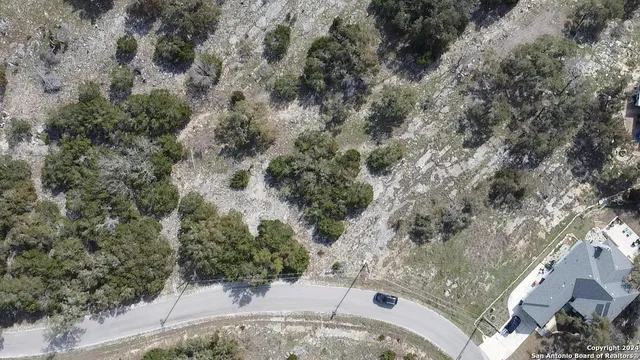 an aerial view of a house with a yard