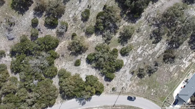 an aerial view of a house with a yard