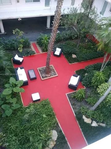 an outdoor space with swimming pool and outdoor seating