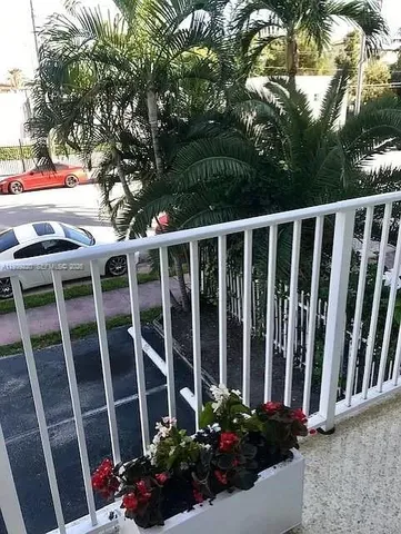 a view of a balcony with flower plants