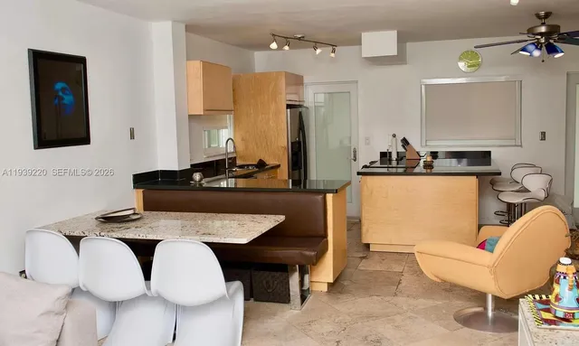 a view of kitchen with dining area and chandelier