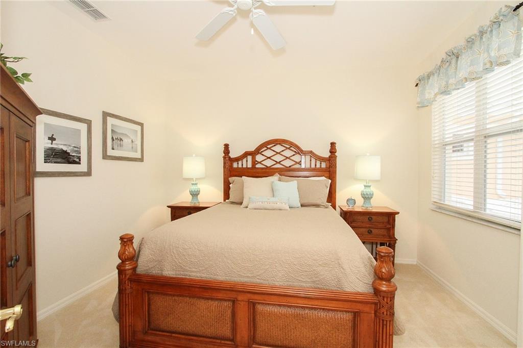 4615 Hawks Nest Drive, Unit B201 Naples, FL 34114 - Photo 12 of 14 a bedroom with a bed and a window