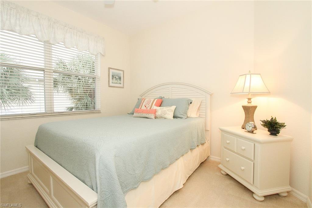 4615 Hawks Nest Drive, Unit B201 Naples, FL 34114 - Photo 14 of 14 a bedroom with a bed and a dresser