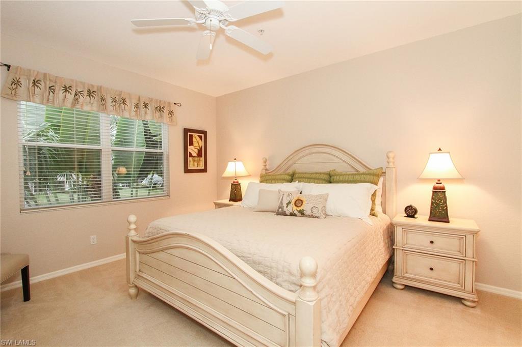 4615 Hawks Nest Drive, Unit B201 Naples, FL 34114 - Photo 8 of 14 a bedroom with a bed and window