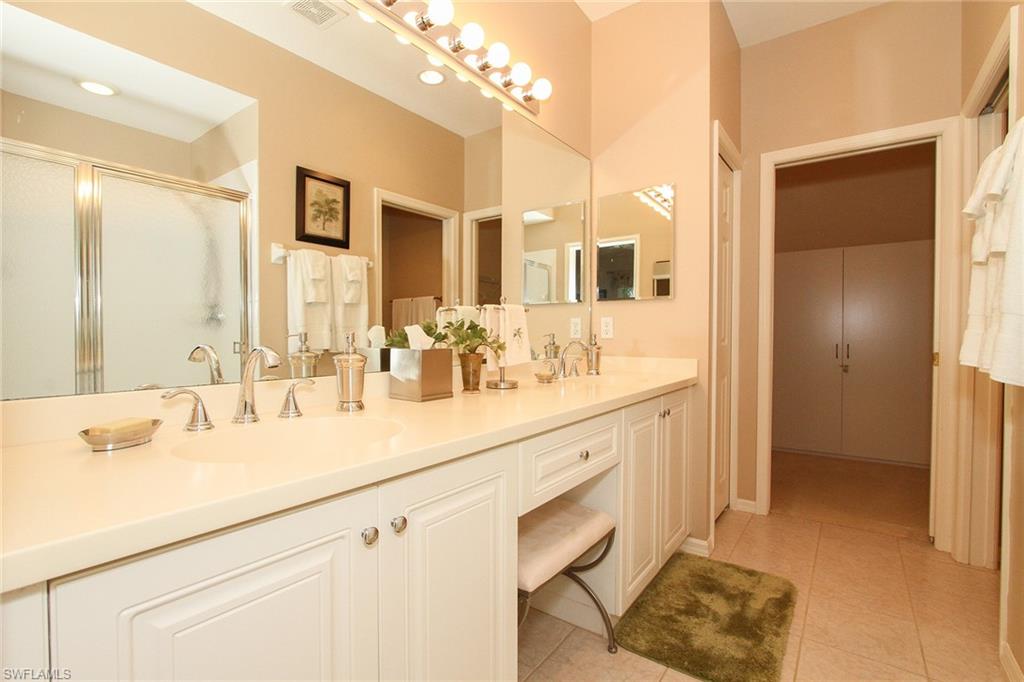 4615 Hawks Nest Drive, Unit B201 Naples, FL 34114 - Photo 10 of 14 a bathroom with a sink double vanity and a mirror