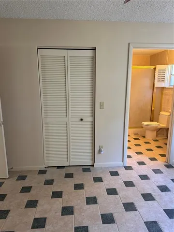 a bathroom with a black and white checkered floor