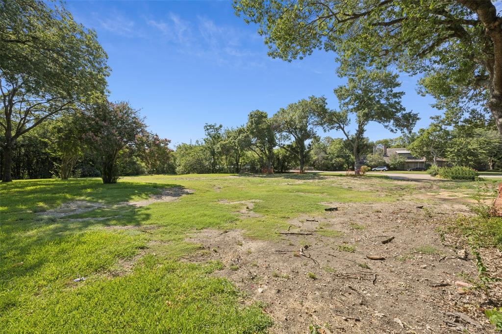 4931 Northaven Road Dallas, TX 75229 - Photo 7 of 8 a view of a green field with wooden fence