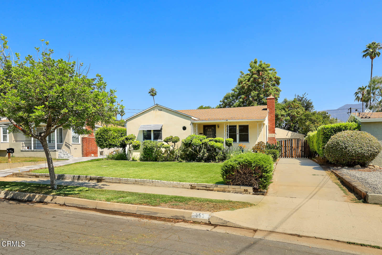 a front view of a house with a garden