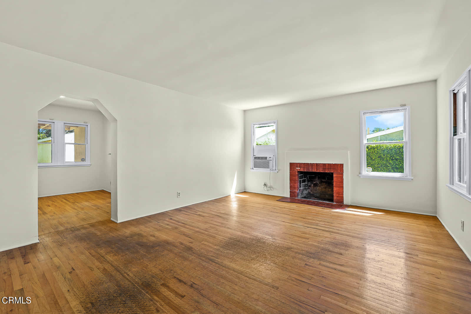 563 Toolen Place Pasadena, CA 91103 - Photo 4 of 12 a view of empty room with wooden floor and fireplace