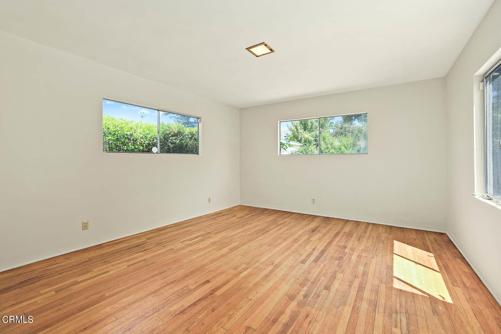 563 Toolen Place Pasadena, CA 91103 - Photo 9 of 12 wooden floor in an empty room with a window
