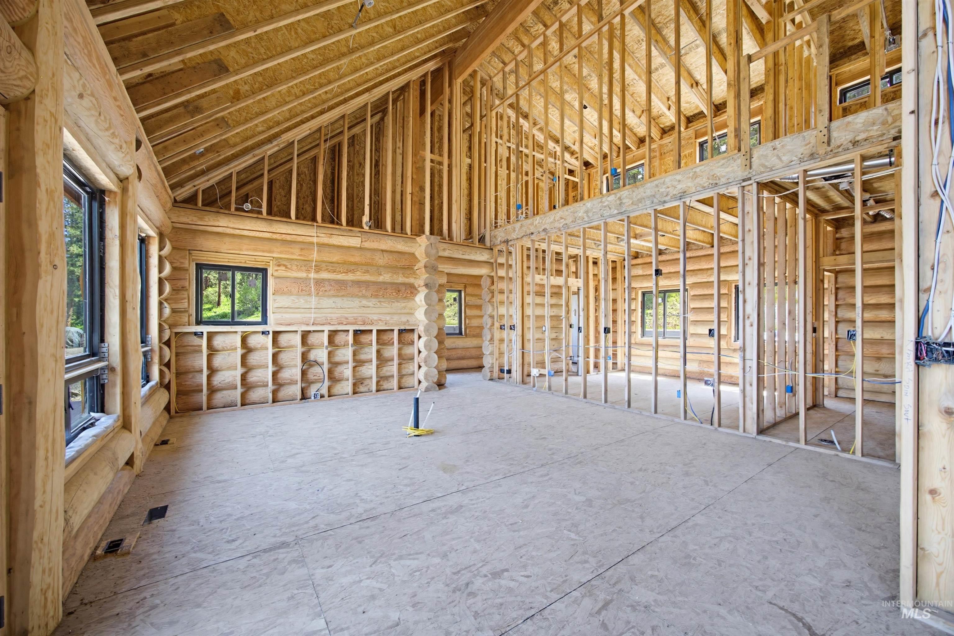 3322 Big Creek Road New Meadows, ID 83654 - Photo 48 of 50 Spacious interior featuring exposed log walls, vaulted ceilings with exposed wood framing, and multiple window openings
