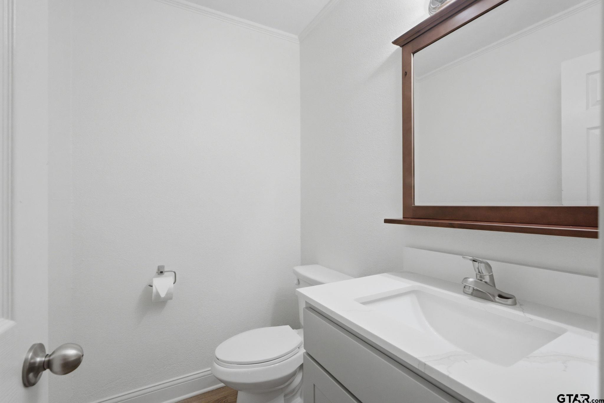 2716 Manilee Lane Tyler, TX 75702 - Photo 11 of 20 a bathroom with a sink toilet and mirror