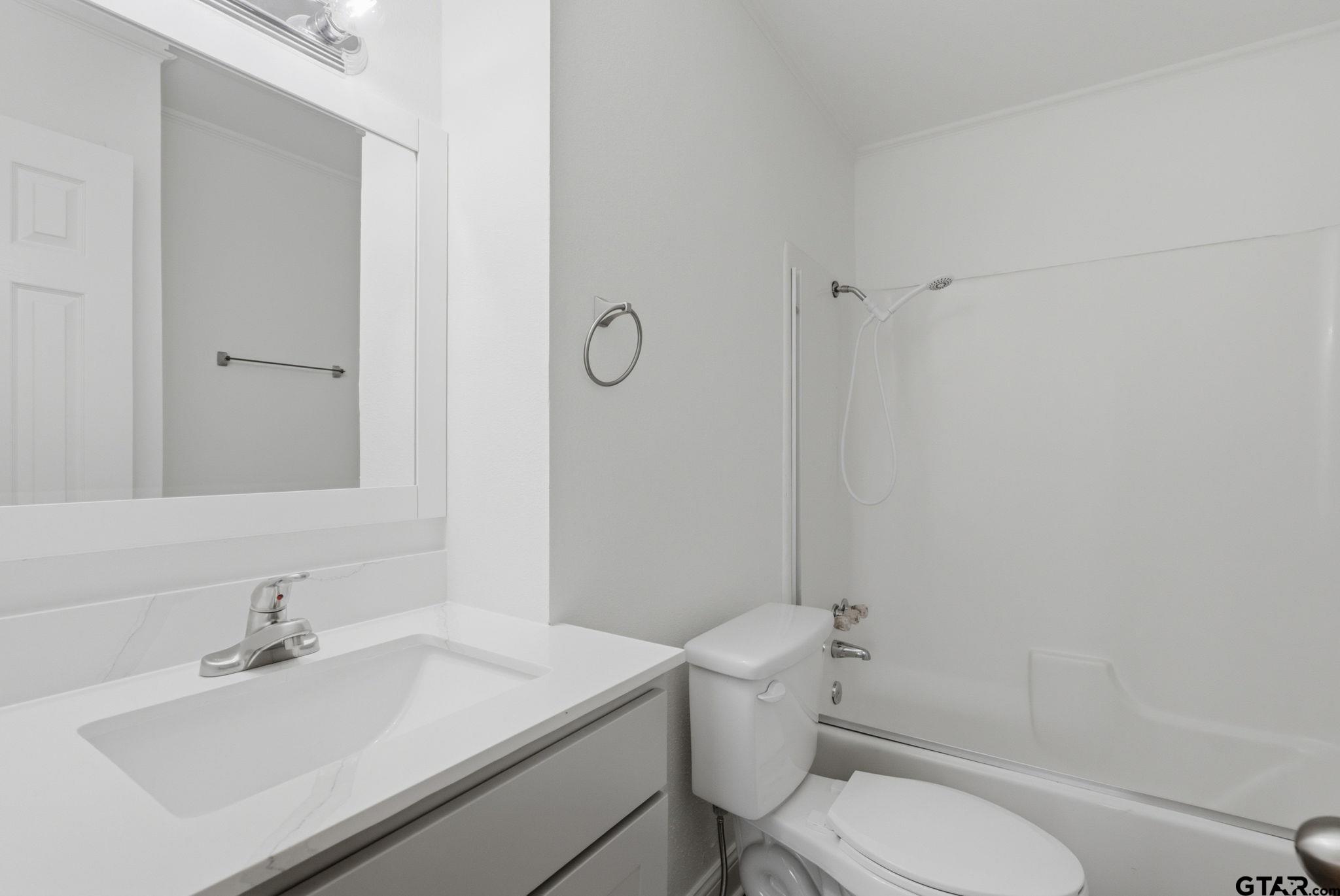 2716 Manilee Lane Tyler, TX 75702 - Photo 14 of 20 a bathroom with a sink toilet and mirror