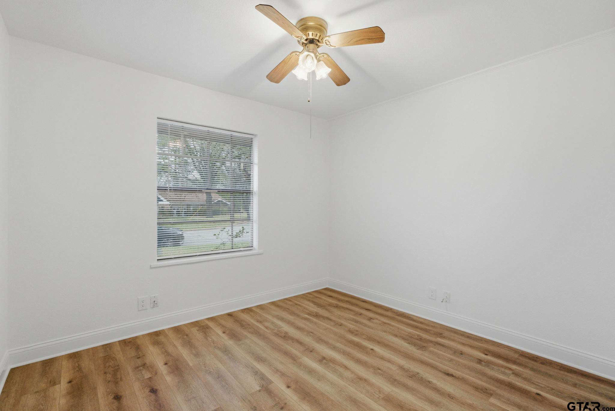 2716 Manilee Lane Tyler, TX 75702 - Photo 16 of 20 an empty room with a window and a chandelier fan