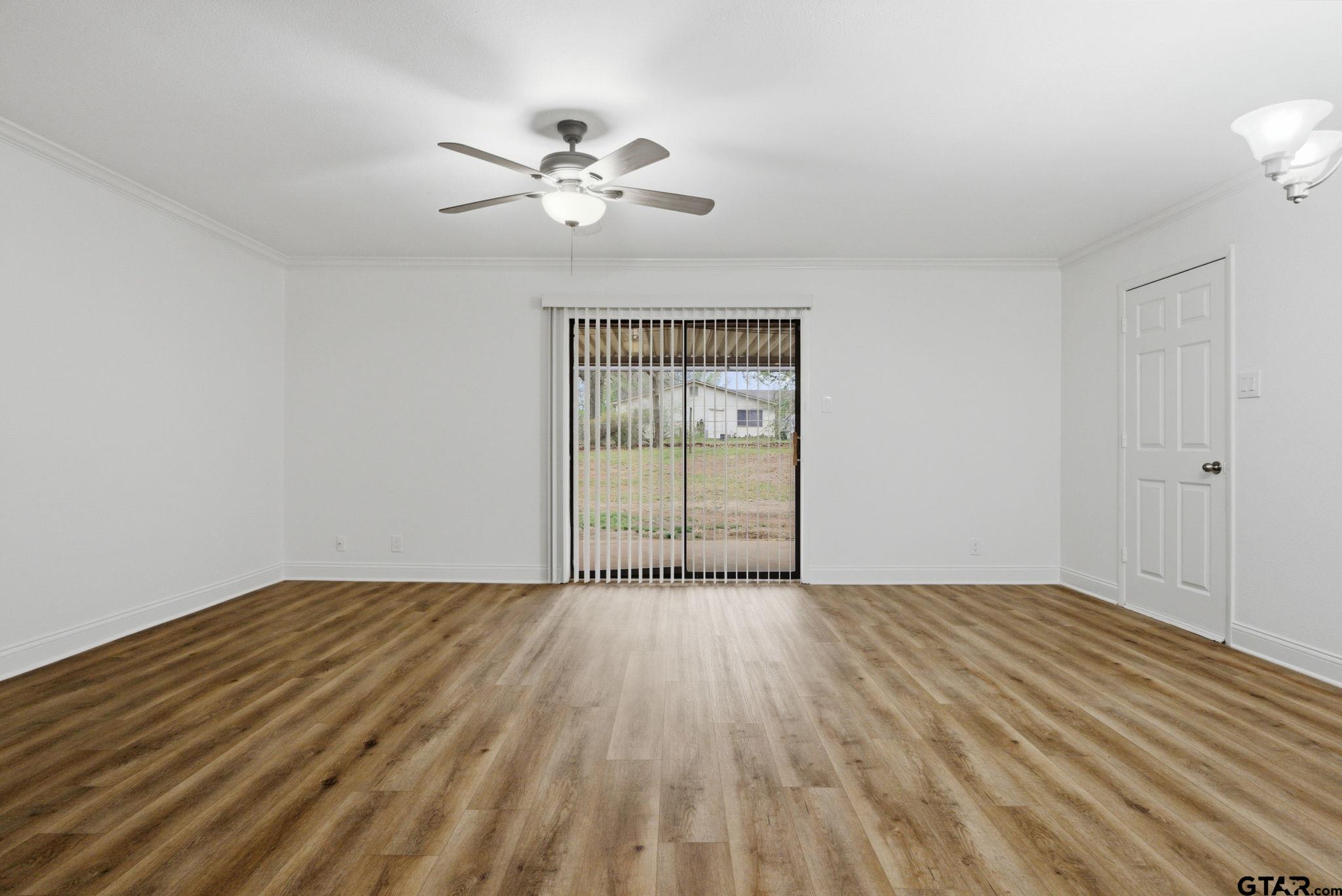 2716 Manilee Lane Tyler, TX 75702 - Photo 3 of 20 a view of an empty room with window and wooden floor