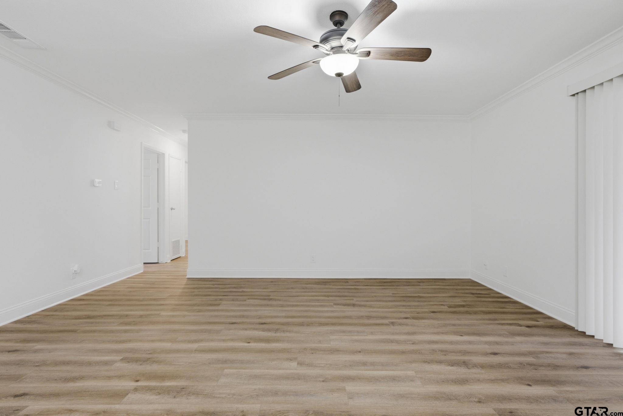 2716 Manilee Lane Tyler, TX 75702 - Photo 4 of 20 a view of an empty room with wooden floor