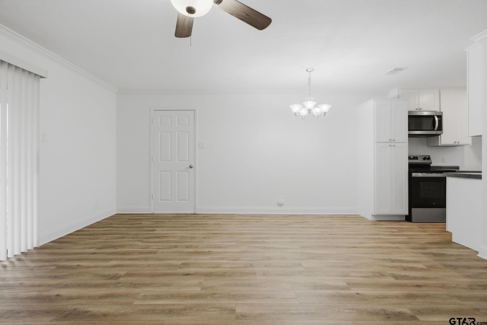 2716 Manilee Lane Tyler, TX 75702 - Photo 5 of 20 a view of empty room with wooden floor and ceiling fan