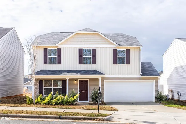 a front view of a house with garden