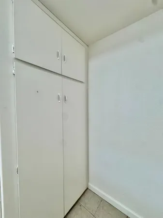 a view of hallway with wooden floor