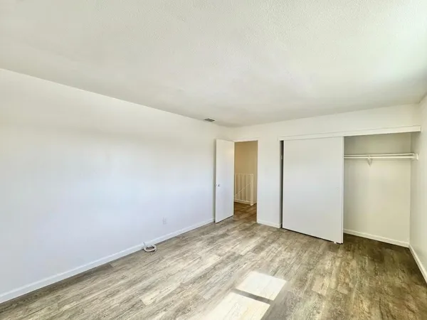 a view of a room with wooden floor and bathroom