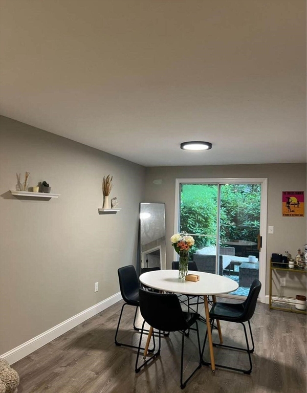135 West Main Street, Unit 26 Barnstable, MA 02601 - Photo 7 of 11 a living room with furniture a window and a table