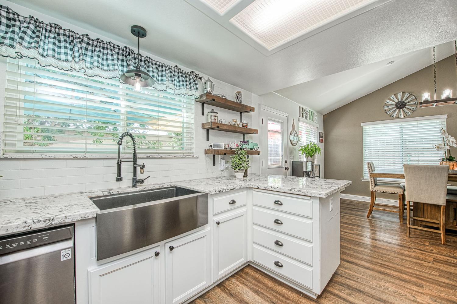 980 North Adler Avenue Clovis, CA 93611 - Photo 17 of 42 a kitchen with granite countertop a sink and cabinets