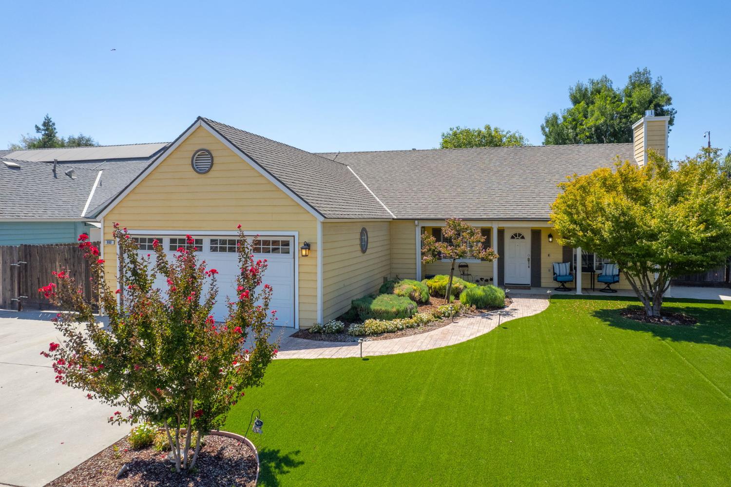 980 North Adler Avenue Clovis, CA 93611 - Photo 2 of 42 a front view of a house with a yard garden and outdoor seating