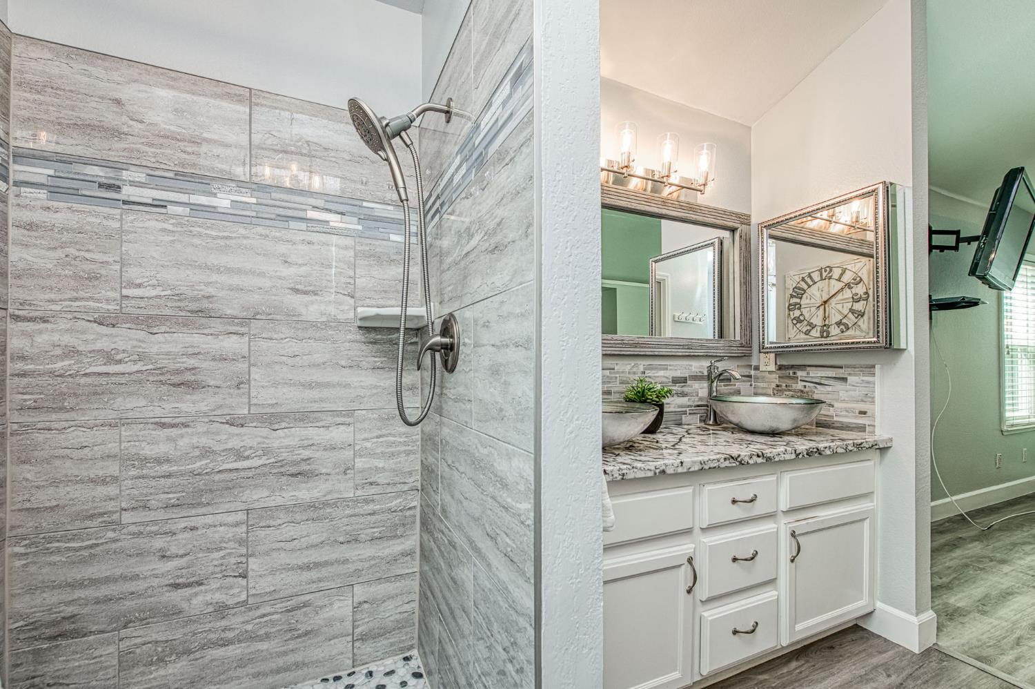 980 North Adler Avenue Clovis, CA 93611 - Photo 27 of 42 a bathroom with a granite countertop sink a mirror and shower