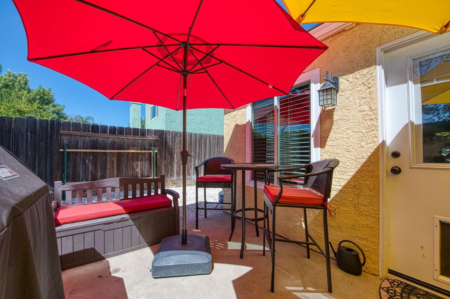 980 North Adler Avenue Clovis, CA 93611 - Photo 37 of 42 a patio with tables and chairs and a umbrella