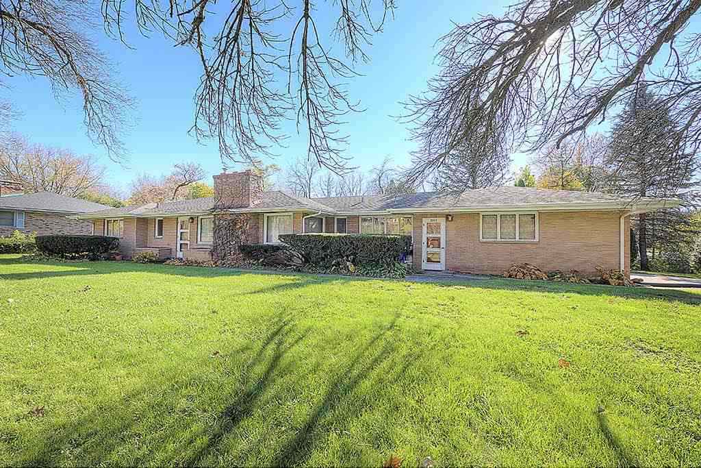3305 Spring Creek Road Rockford, IL 61107 - Photo 1 of 20 a front view of a house with a garden