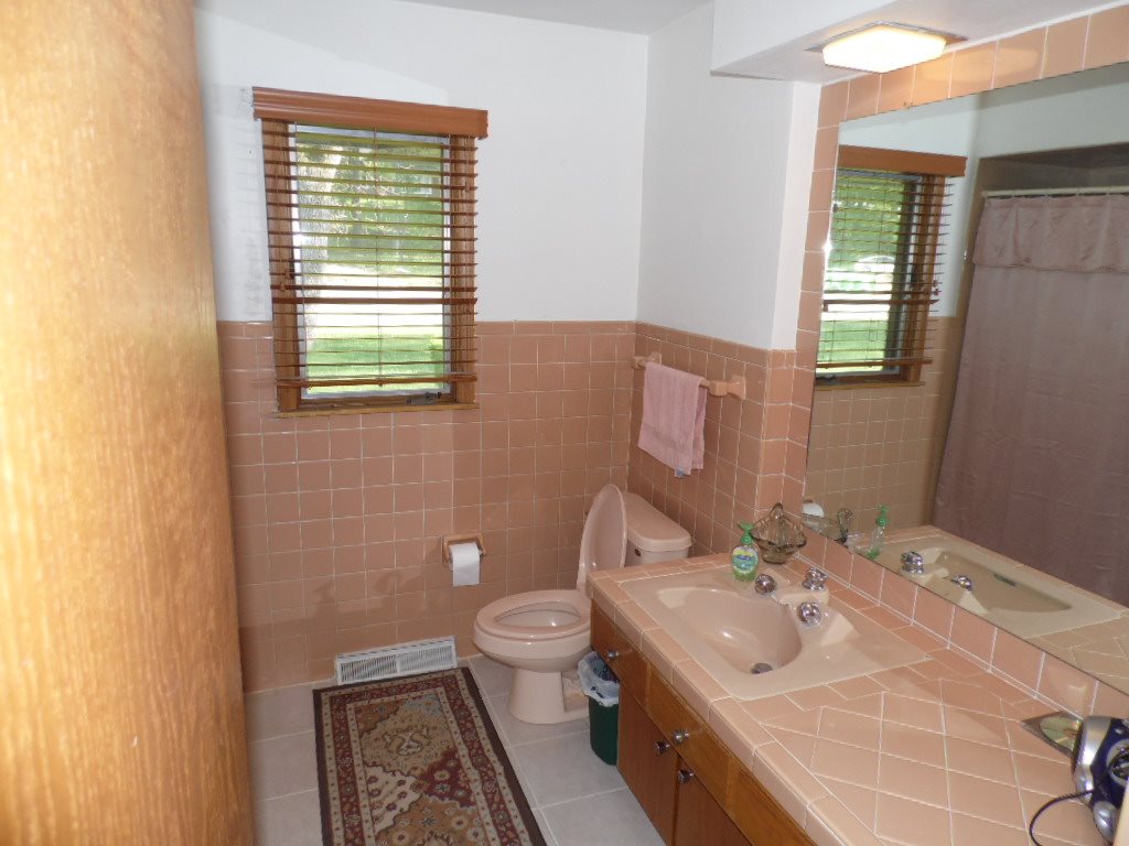 3305 Spring Creek Road Rockford, IL 61107 - Photo 13 of 20 a bathroom with a sink toilet and mirror