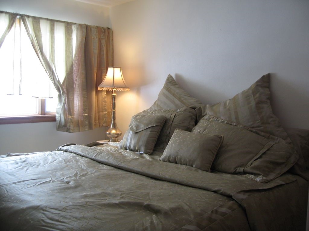 3305 Spring Creek Road Rockford, IL 61107 - Photo 9 of 20 a bed sitting in a bedroom next to a window