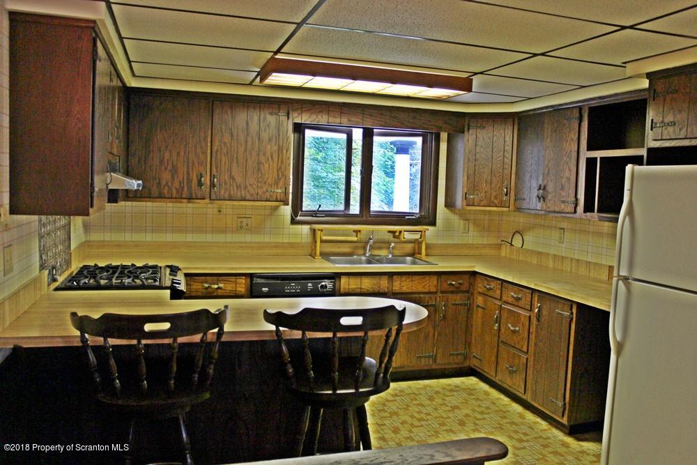 122 Old State Road Moscow, PA 18444 - Photo 10 of 20 a kitchen with a sink refrigerator and cabinets