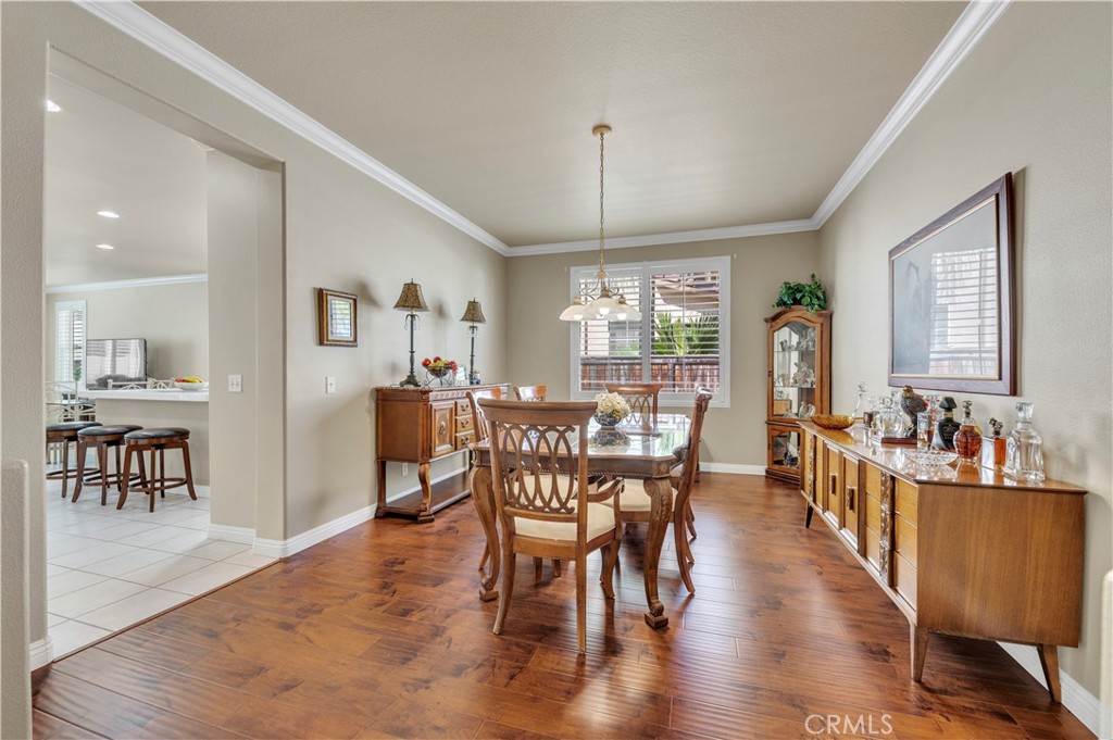 37678 Newcastle Road Murrieta, CA 92563 - Photo 15 of 44 a view of a dining room with furniture window and wooden floor