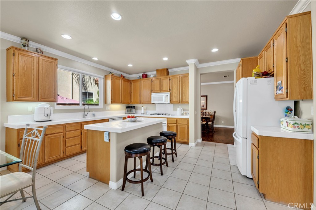 37678 Newcastle Road Murrieta, CA 92563 - Photo 17 of 44 a kitchen with granite countertop a sink appliances cabinets and furniture