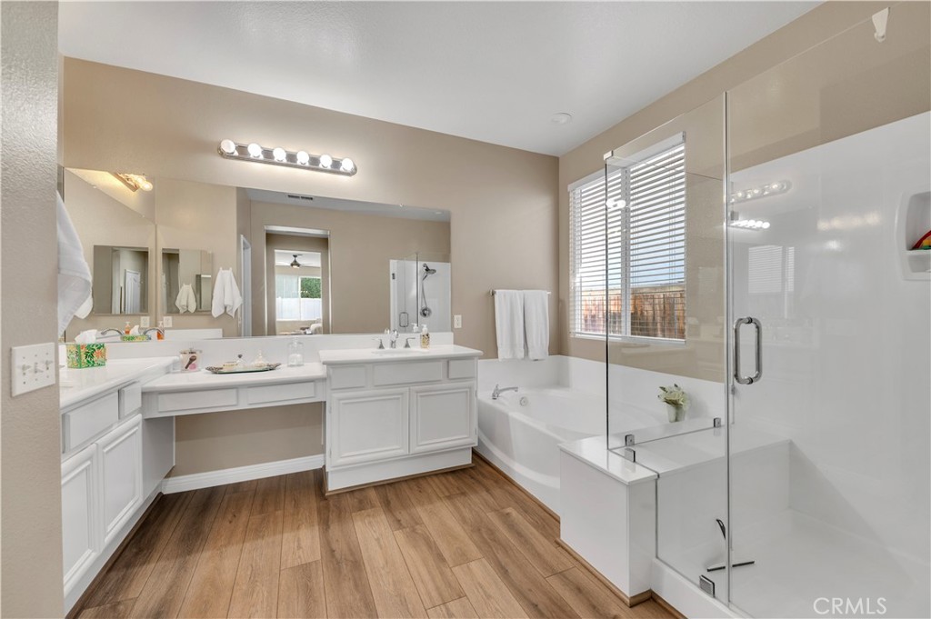 37678 Newcastle Road Murrieta, CA 92563 - Photo 26 of 44 a bathroom with a tub a sink shower and mirror