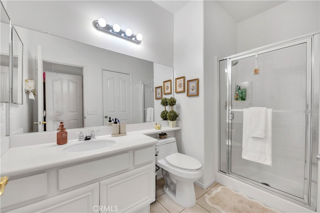 37678 Newcastle Road Murrieta, CA 92563 - Photo 32 of 44 a bathroom with a toilet a sink and a mirror